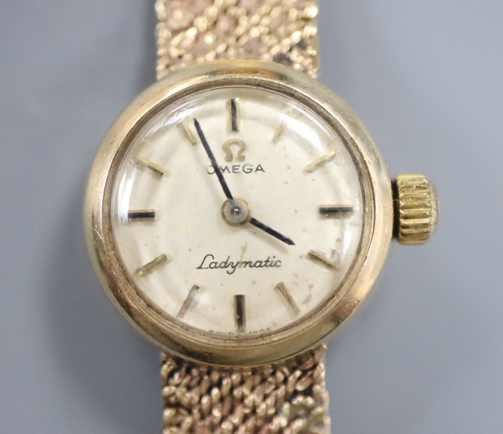 A 9ct gold ladys Omega gold manual wind wristwatch on 9ct gold bracelet, overall length 17.8cm, gross 23.8 grams.